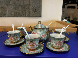 Six piece tea set with spoons and saucers